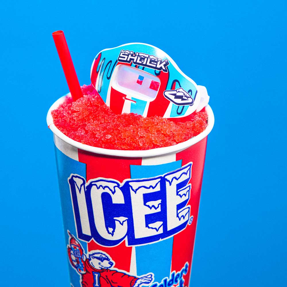 Lifestyle Image of Shock Doctor ICEE Drip Max AirFlow Football Mouthguard Sitting on Icee in a Cup (Cherry Flavor)