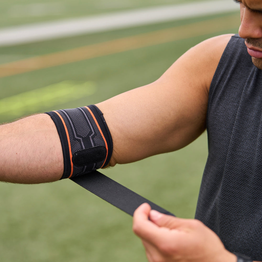 Athlete Strapping on Shock Doctor Compression Knit Tennis/Golf Elbow Sleeve with Gel Support & Strap