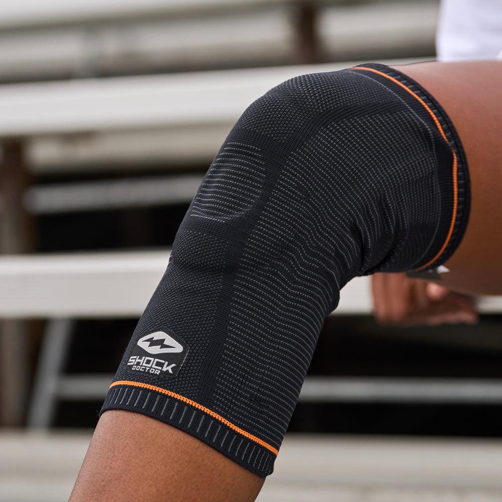 Detail View of Athlete Bending Knee While Wearing Shock Doctor Ultra Knit Knee Support with Full Patella Gel & Stays 