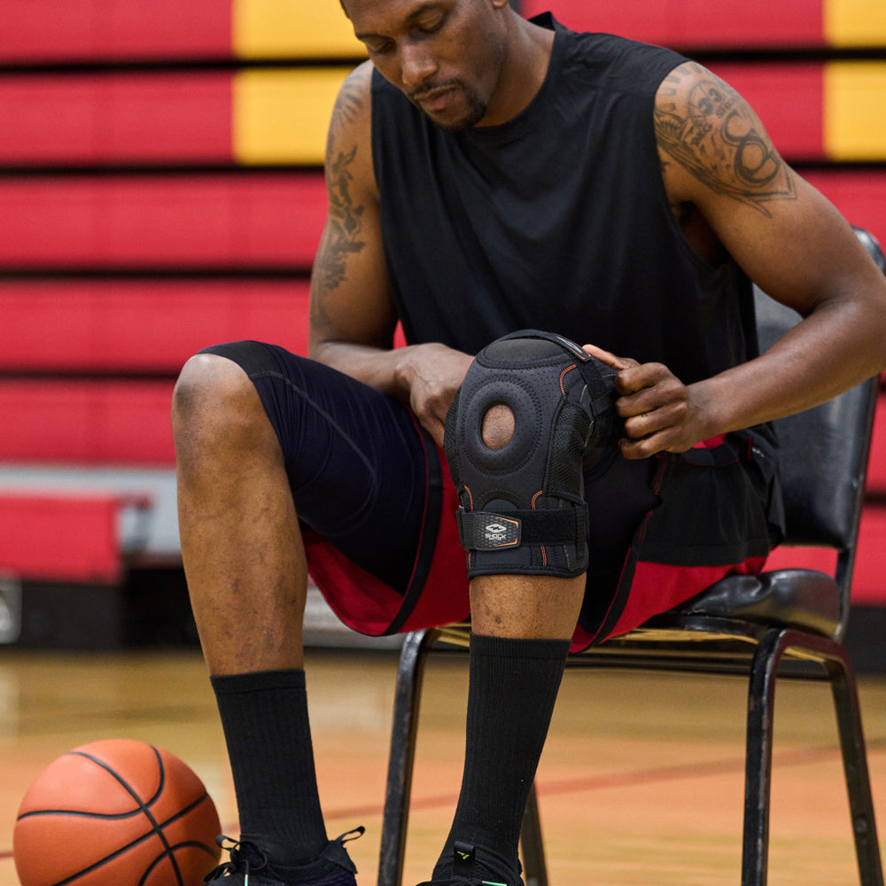Athlete Fitting Shock Doctor Ultra Knee Support with Bilateral Hinges Over Knee For a Better Fit