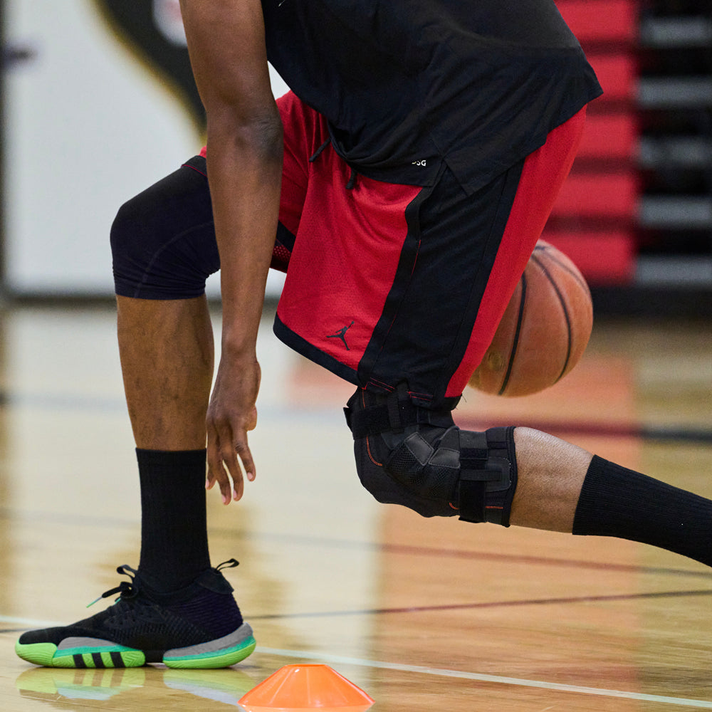 Athlete Wearing Shock Doctor Ultra Knee Support with Bilateral Hinges While Paying Pick Up Basketball