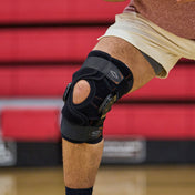 Athlete Wearing Shock Doctor Knee Brace with Dual Wrap & Heavy-Duty Hinges on Court