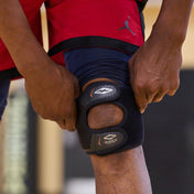 Athlete Adjusting Shock Doctor Dual Strap Knee Wrap Around Knee