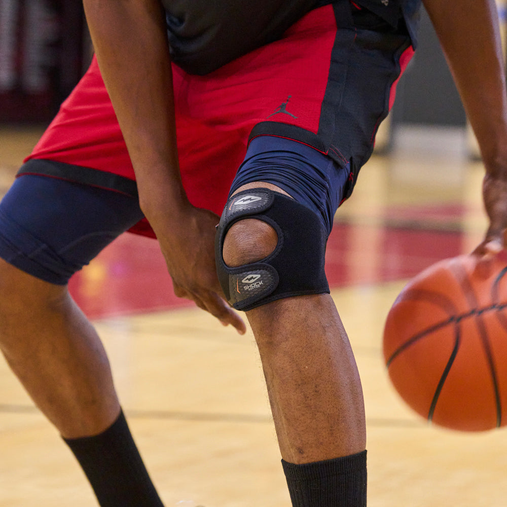 Athlete Wearing Shock Doctor Dual Strap Knee Wrap While Playing Basketball