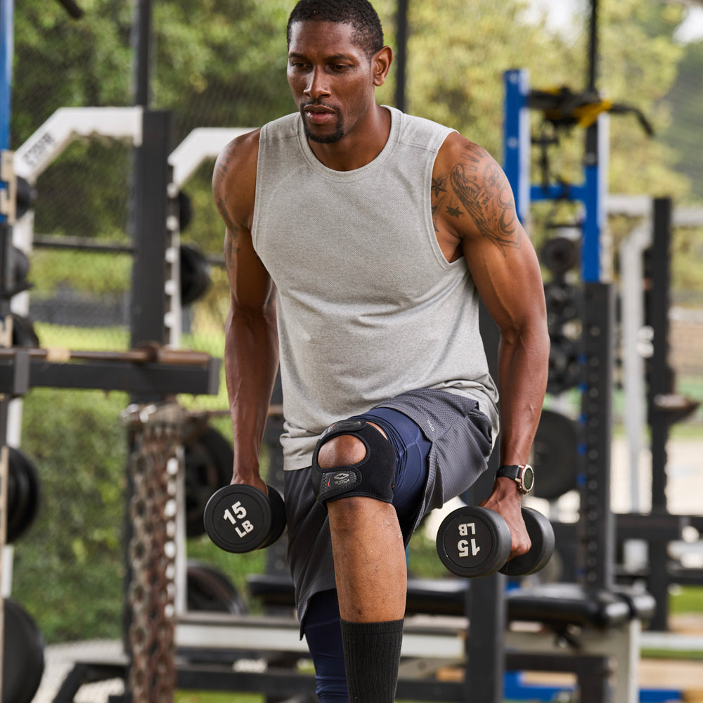 Athlete Wearing Shock Doctor Dual Strap Knee Wrap While Lifting Weights