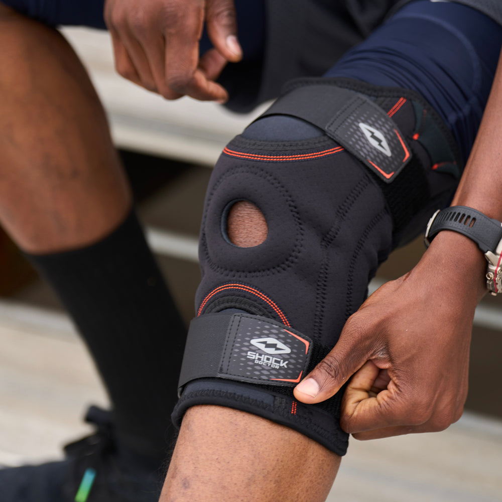 Athlete Adjusting the Shock Doctor Knee Stabilizer with Flexible Support Stays for a Better Fit