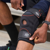 Athlete Adjusting the Shock Doctor Knee Stabilizer with Flexible Support Stays for a Better Fit