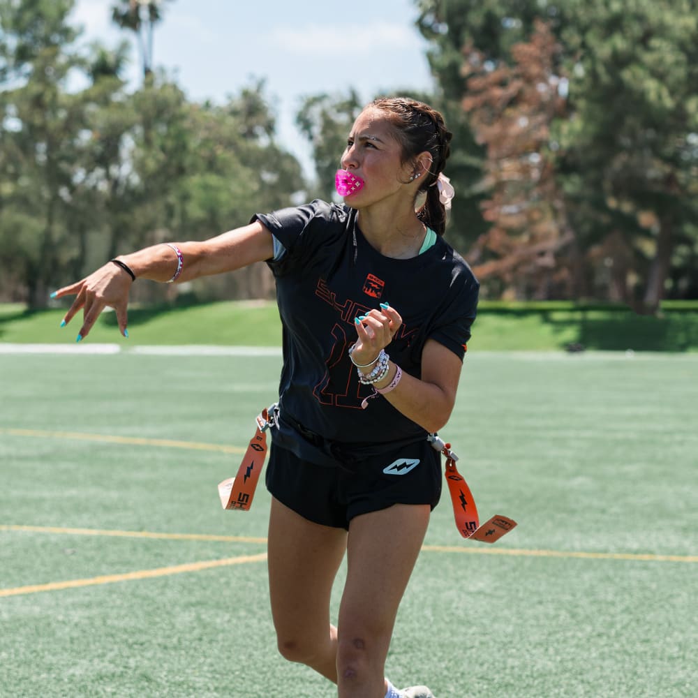 Youth Female Flag Football Athlete Wearing Shock Doctor Translucent Pink Max AirFlow Football Lip Guard