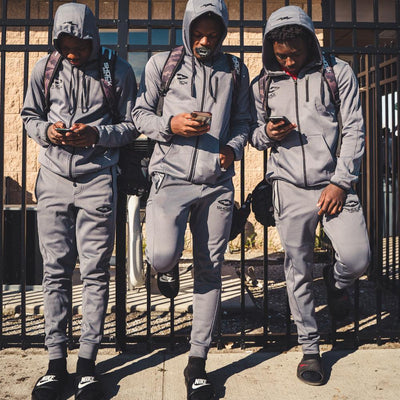 Youth Football Players Wearing Shock Doctor Athletic Gray Jogger Pants and Athletic Grey Hoodies
