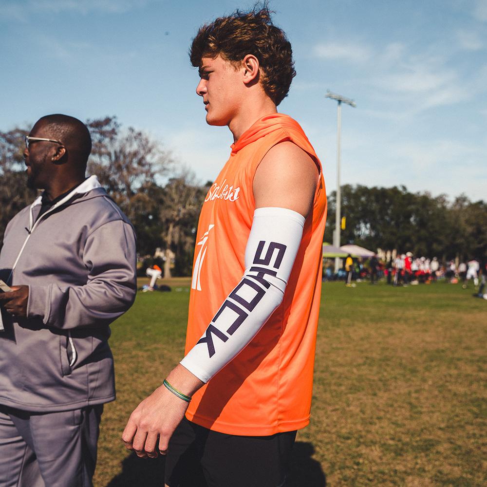Youth 7v7 Football Player Wearing White Shock Doctor Compression Arm Sleeve