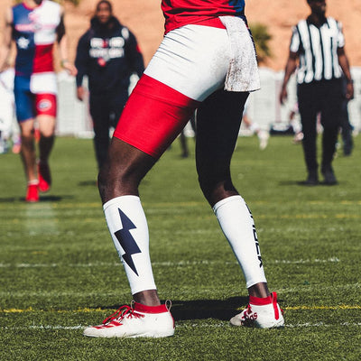 Lifestyle Shot of Youth 7v7 Football Player Wearing Shock Doctor Shock Doctor Compression Calf Sleeves - White