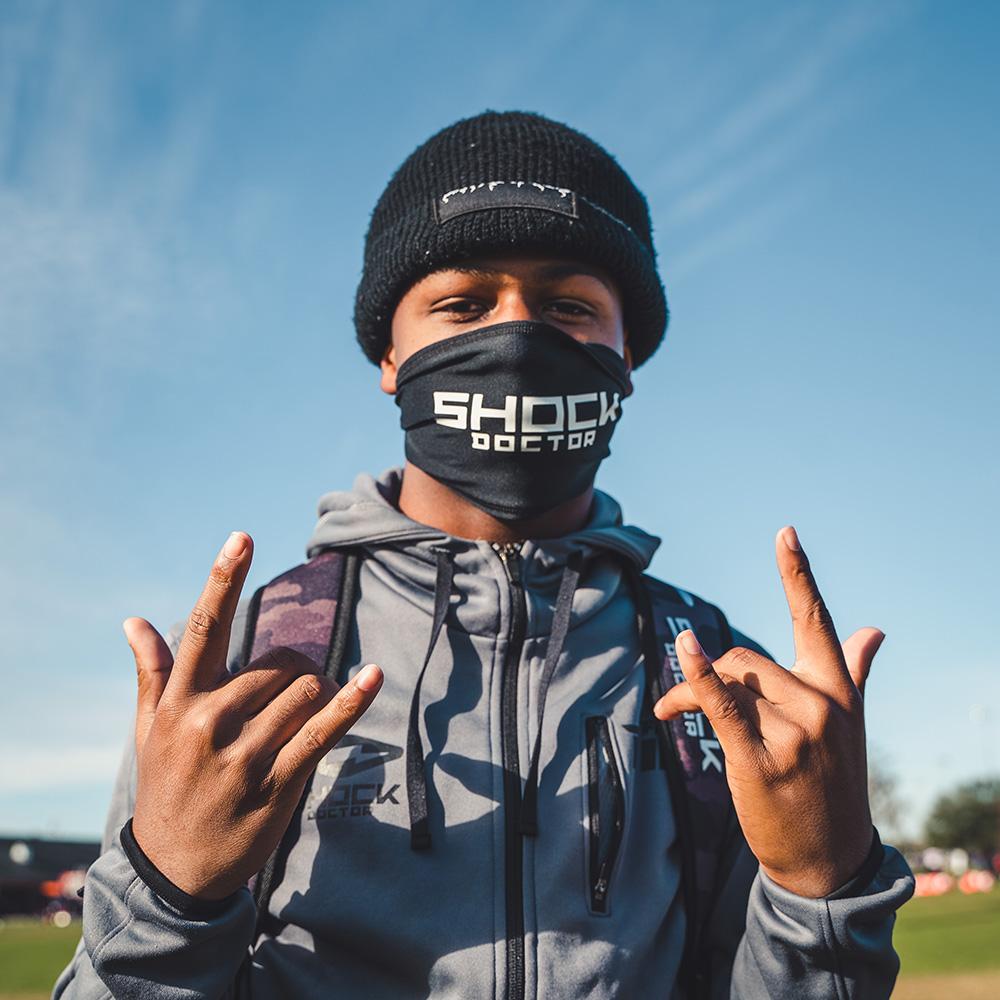 Youth 7v7 Football Athlete Wearing Shock Doctor Black Performance Headband As Face Covering