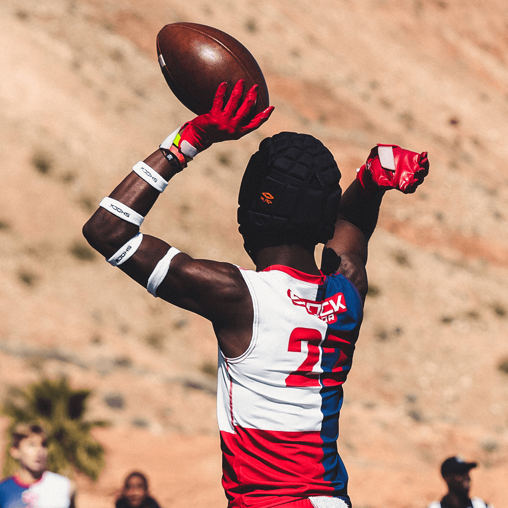 Youth 7v7 Football Athlete Holding Football While Wearing Shock Doctor Football Arm Bands