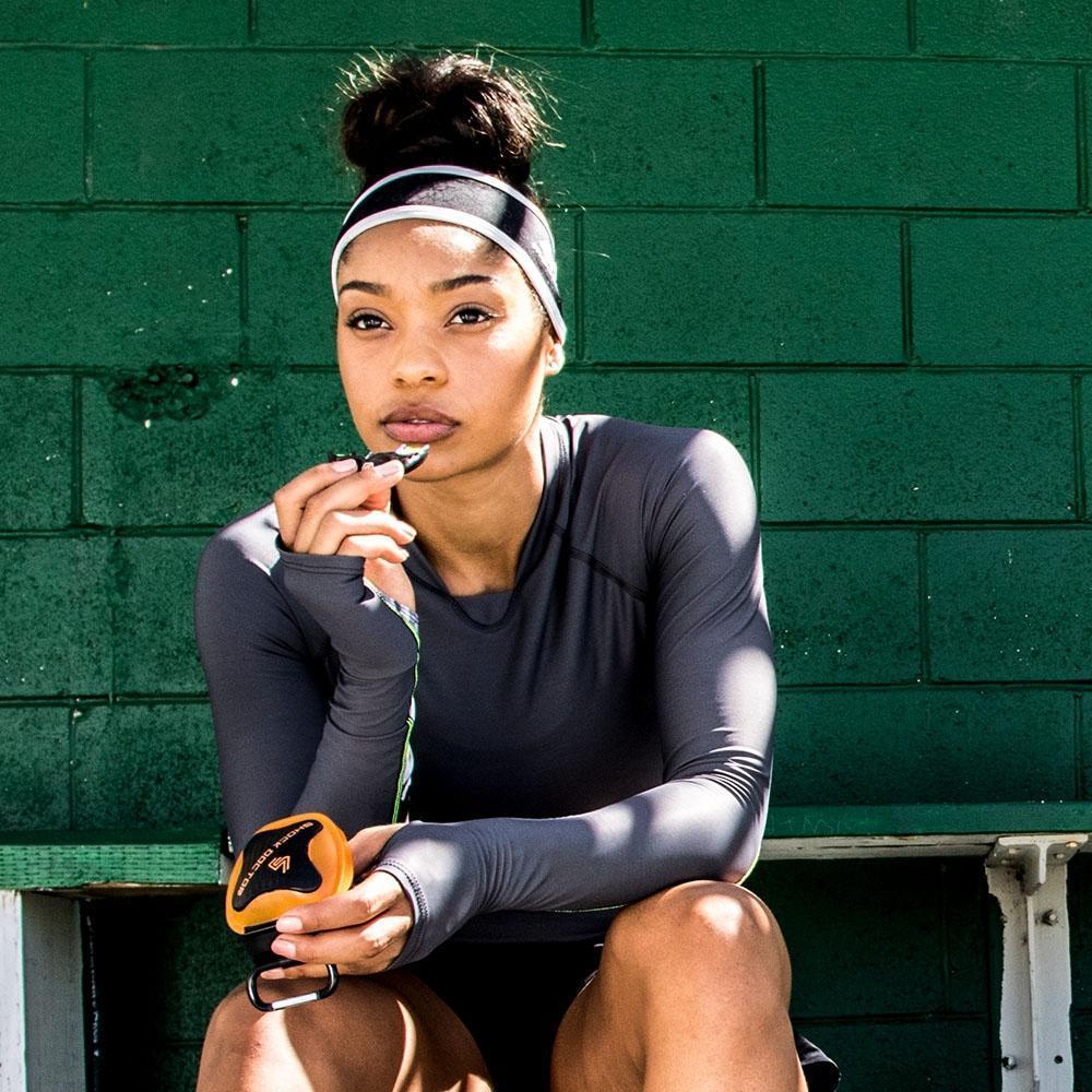 Athlete pulling mouthguard out of Shock Doctor Mouthguard Case